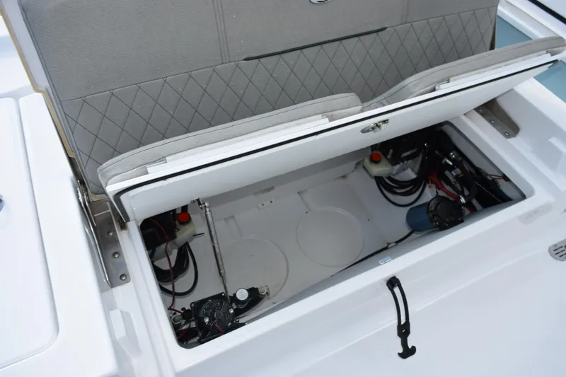 Slide: The Image of 2021 Sportsman Tournament 234 Bay Boat storage compartment with open seat revealing internal components. - 25