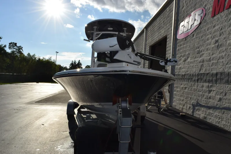 Slide: The Image of 2021 Sportsman Tournament 234 Bay Boat parked outside dealership under bright sun. - 3
