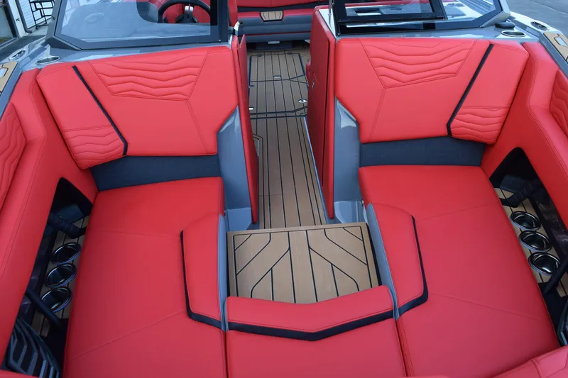 Slide: The Image of 2025 Nautique Super Air Nautique G23 interior with red seating and wood flooring. - 14