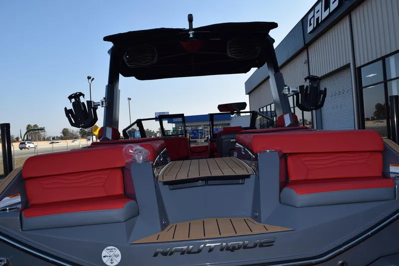 Slide: The Image of 2025 Nautique Super Air Nautique G23 boat with red seating and sleek design. - 16