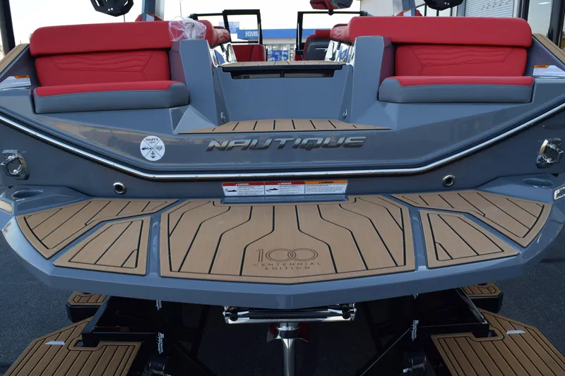 Slide: The Image of 2025 Nautique Super Air Nautique G23 boat with red seating and teak-style deck. - 17