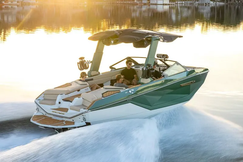 Slide: The Image of Manufacturer Provided Image: 2025 Nautique Super Air Nautique G23 boat cruising on a sunny lake. - 25