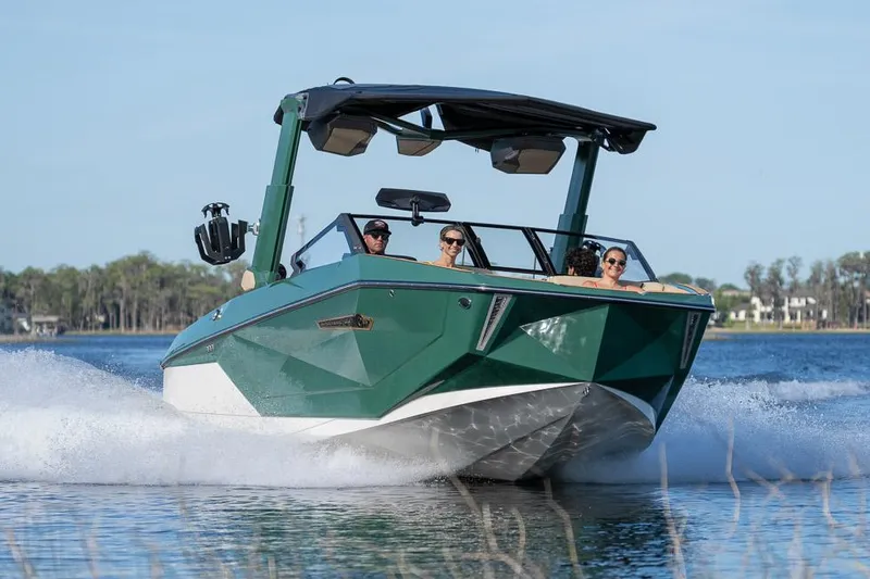 Slide: The Image of Manufacturer Provided Image: 2025 Nautique Super Air Nautique G23 boat cruising on a lake with passengers. - 26