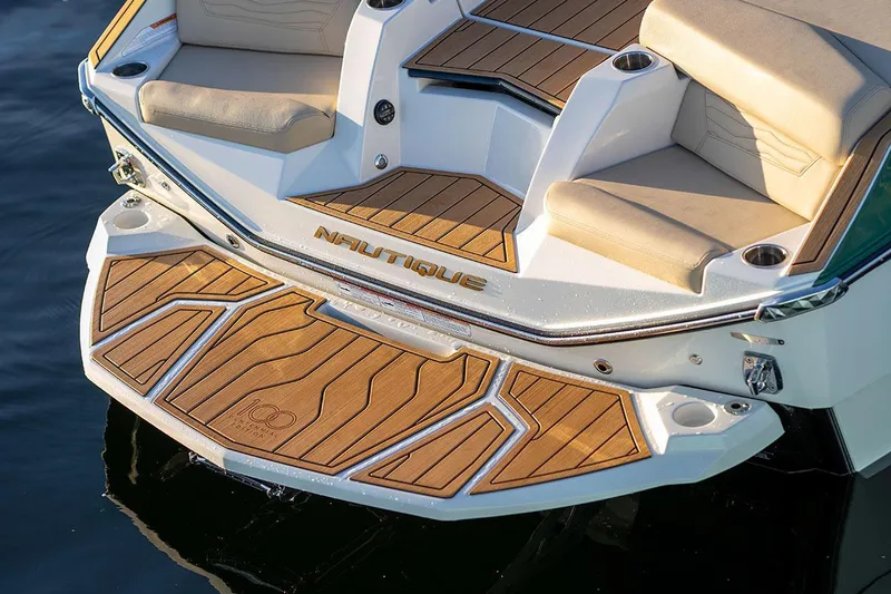 Slide: The Image of Manufacturer Provided Image: 2025 Nautique Super Air Nautique G23 boat with teak deck and cushioned seating. - 29