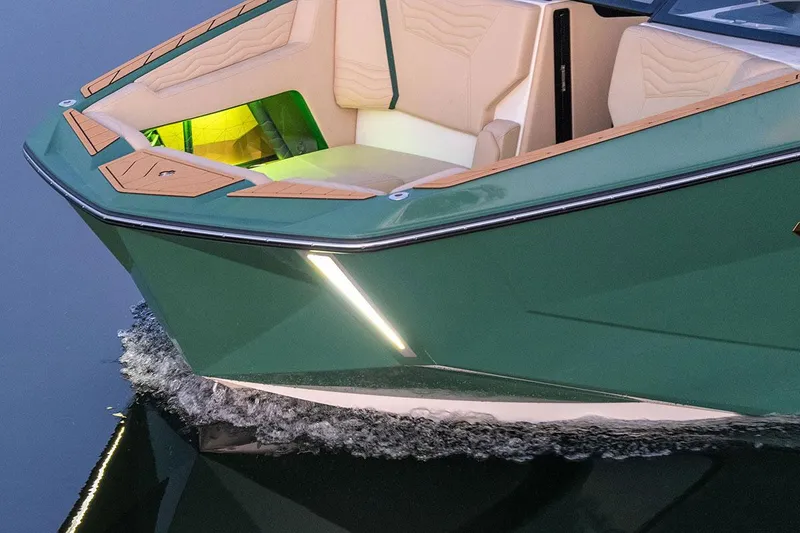 Slide: The Image of Manufacturer Provided Image: 2025 Nautique Super Air Nautique G23 boat with sleek design and illuminated interior. - 30