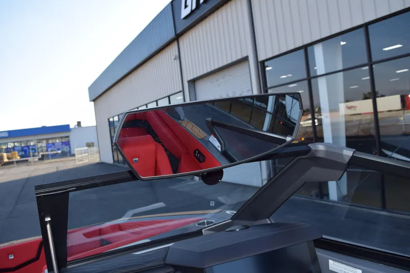 Slide: The Image of 2025 Nautique Super Air Nautique G23 boat mirror reflecting red interior. - 8