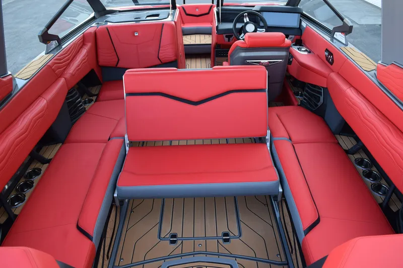 Slide: The Image of 2025 Nautique Super Air Nautique G23 interior with red seating and modern design. - 9