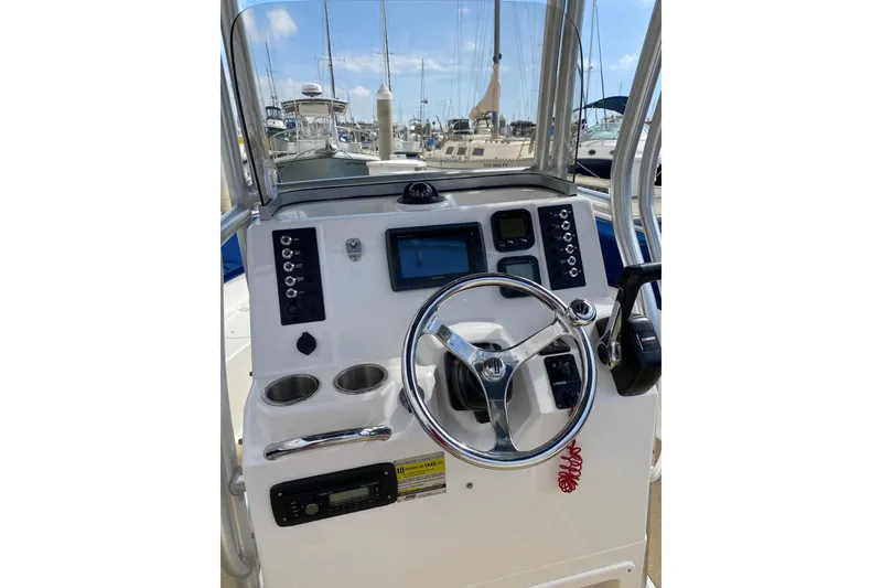 Slide: The Image of 2014 Robalo R222 Center Console boat dashboard with steering wheel and controls. - 13