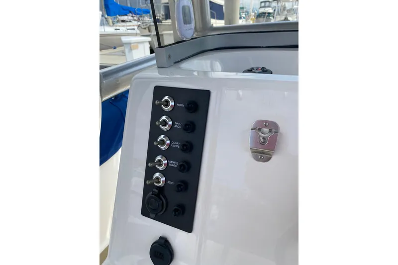 Slide: The Image of 2014 Robalo R222 Center Console boat dashboard with control switches and panel. - 20