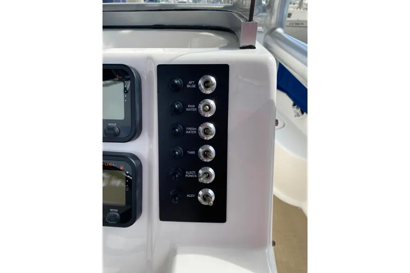 Slide: The Image of Control panel of 2014 Robalo R222 Center Console boat with labeled switches. - 21