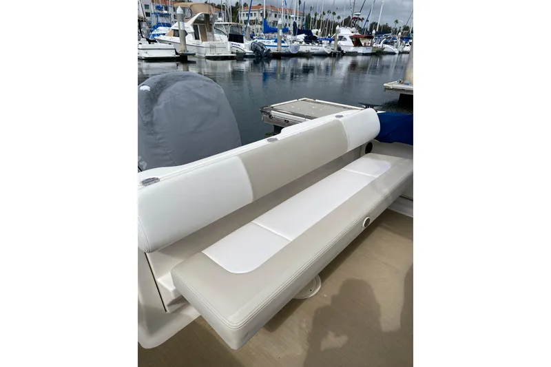 Slide: The Image of 2014 Robalo R222 Center Console boat with cushioned seating at marina. - 6