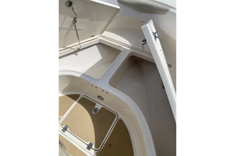 Slide: The Image of 2014 Robalo R222 Center Console boat storage compartments open, showcasing interior space. - 7