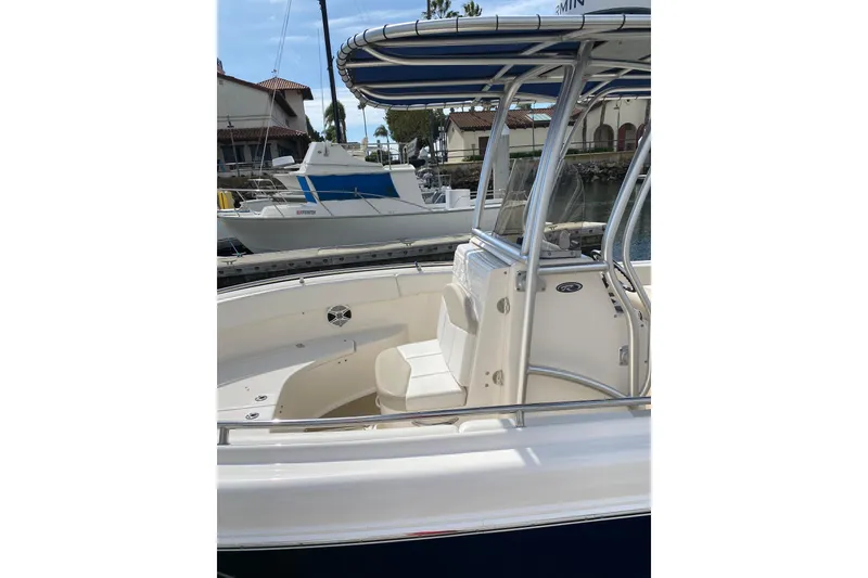 Slide: The Image of 2014 Robalo R222 Center Console boat docked, featuring sleek design and spacious seating. - 8