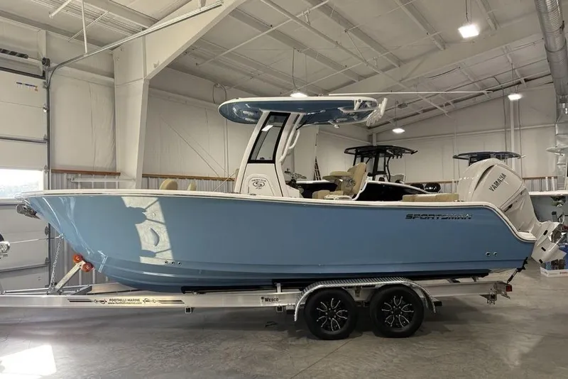 The Image of 2026 Sportsman Heritage 231 Center Console boat in a showroom on a trailer. - 1
