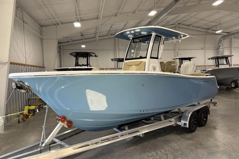 Slide: The Image of 2026 Sportsman Heritage 231 Center Console boat in a showroom on a trailer. - 10