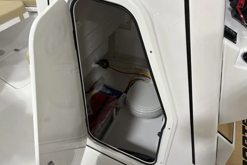 Slide: The Image of Open storage compartment on 2026 Sportsman Heritage 231 Center Console boat. - 11