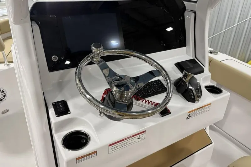 Slide: The Image of 2026 Sportsman Heritage 231 Center Console helm with steering wheel and controls. - 16
