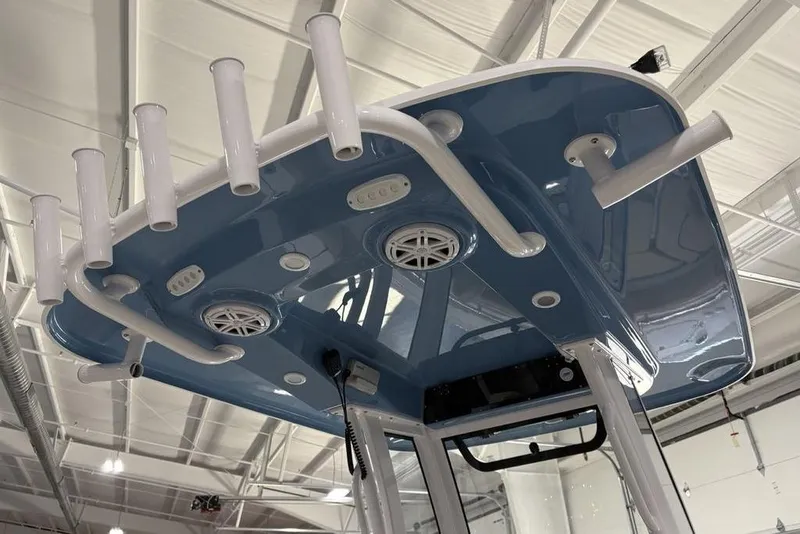 Slide: The Image of 2026 Sportsman Heritage 231 Center Console boat with rod holders and speakers on the T-top. - 19