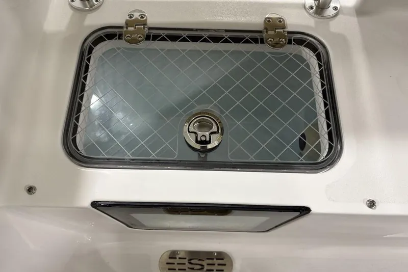 Slide: The Image of 2026 Sportsman Heritage 231 Center Console livewell with secure latch and grid design. - 23