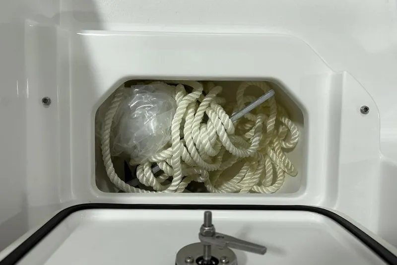 Slide: The Image of Storage compartment with rope on a 2026 Sportsman Heritage 231 Center Console boat. - 26