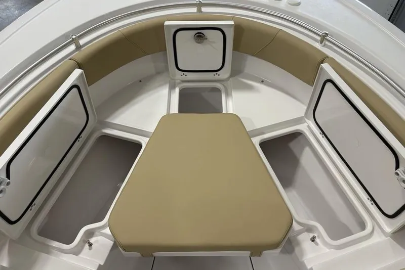 Slide: The Image of 2026 Sportsman Heritage 231 Center Console boat interior with tan seating and storage compartments. - 3