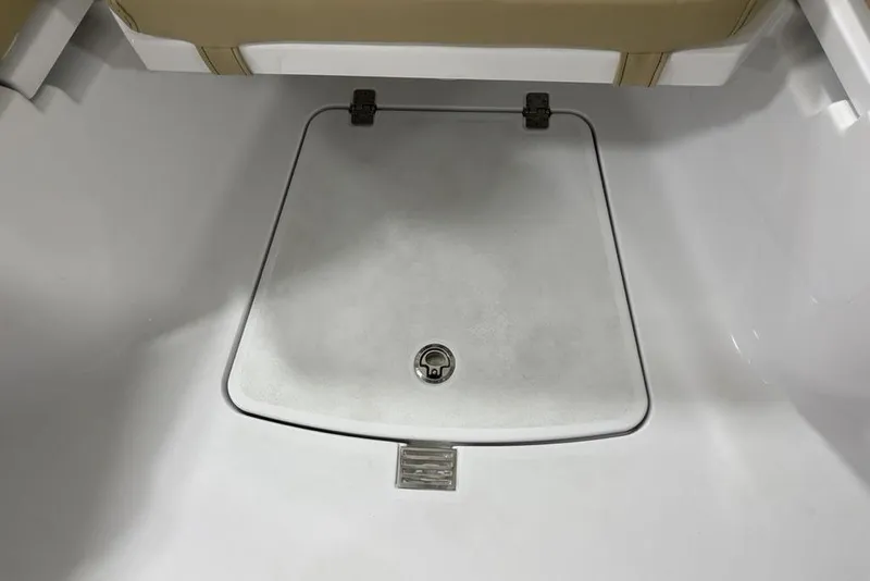 Slide: The Image of 2026 Sportsman Heritage 231 Center Console storage compartment with secure latch. - 4