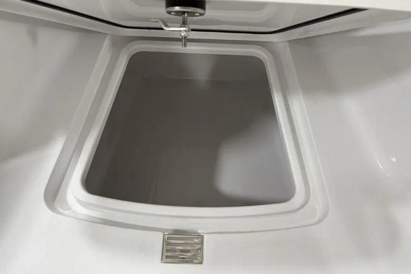 Slide: The Image of 2026 Sportsman Heritage 231 Center Console storage compartment, open and empty. - 7