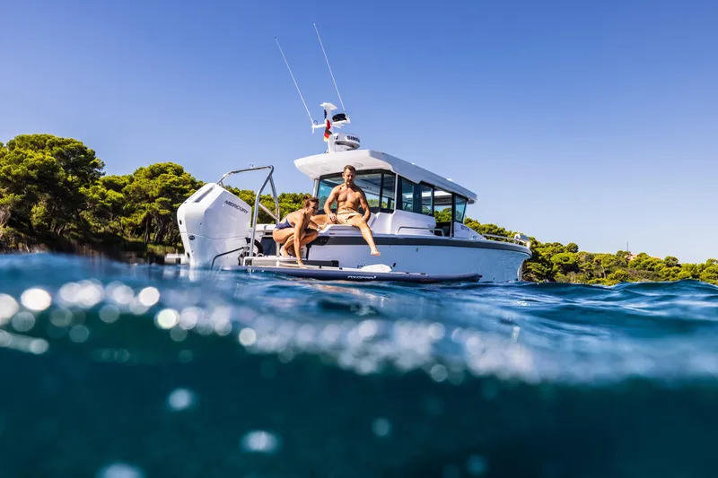 Slide: The Image of 2026 Axopar 29 XC Aft Sofa Twin 200 Brabus Sandstone boat, sleek design, modern features. - 9