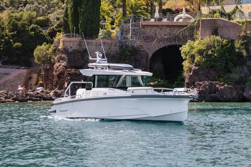 The Image of 2026 Axopar 29 XC Aft Sofa Twin 200 Brabus Sandstone on serene lake. - 0