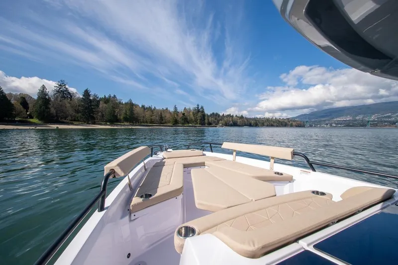 Slide: The Image of 2026 Axopar 29 XC Cross Cabin boat on serene lake with scenic forest backdrop. - 8