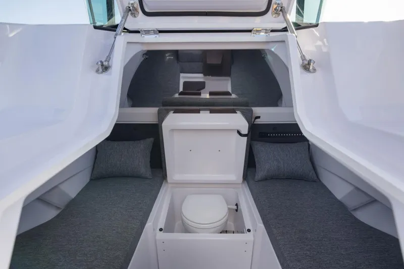 Slide: The Image of 2026 Axopar 29 XC Cross Cabin interior with seating and compact toilet. - 28