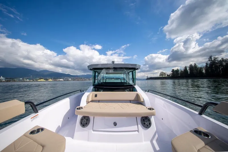 Slide: The Image of 2026 Axopar 29 XC Cross Cabin boat on calm water under a blue sky. - 7