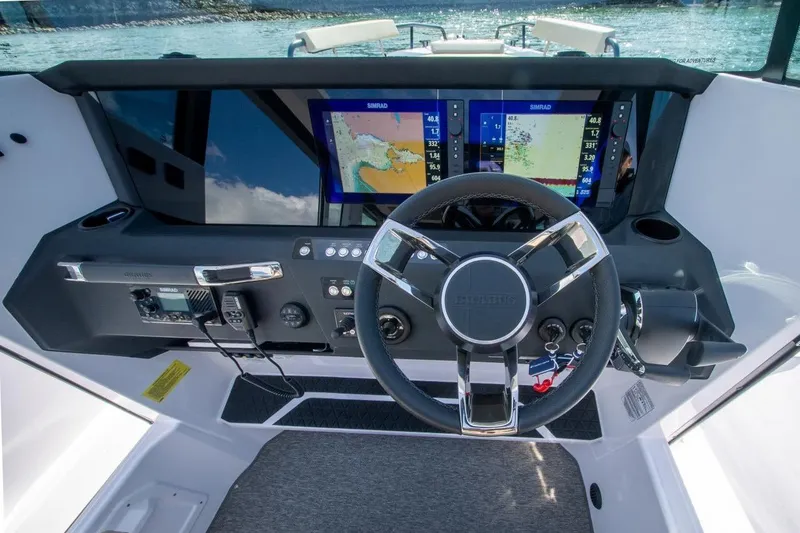 Slide: The Image of 2026 Axopar 29 XC Cross Cabin dashboard with navigation screens and steering wheel. - 21