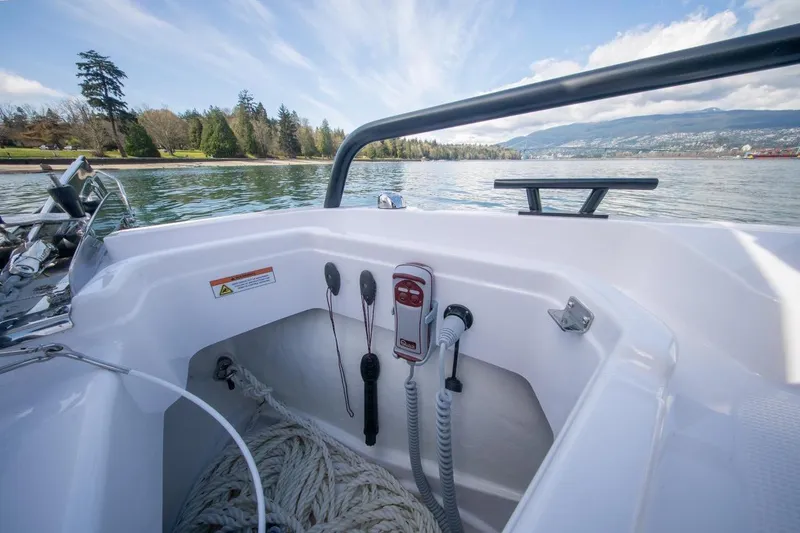 Slide: The Image of 2026 Axopar 29 XC Cross Cabin boat interior with ropes and controls, scenic water view. - 15