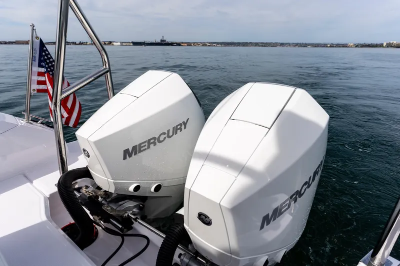 Slide: The Image of Twin Mercury outboard engines on 2026 Axopar 29 XC Cross Cabin, with American flag. - 6