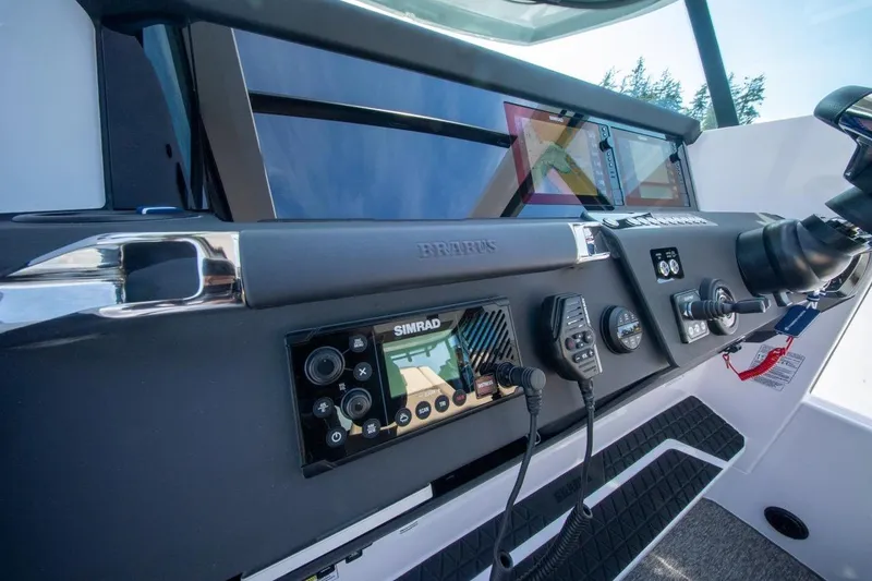 Slide: The Image of 2026 Axopar 29 XC Cross Cabin dashboard with advanced navigation and control systems. - 23