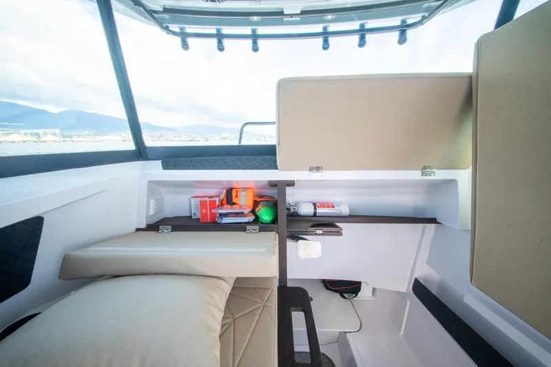 Slide: The Image of Interior of 2026 Axopar 29 XC Cross Cabin with storage and safety equipment. - 17