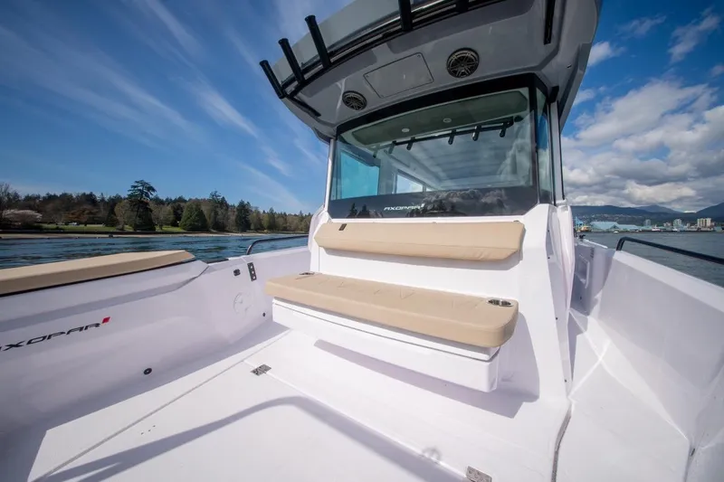 Slide: The Image of 2026 Axopar 29 XC Cross Cabin boat with seating, scenic water view, and clear skies. - 9