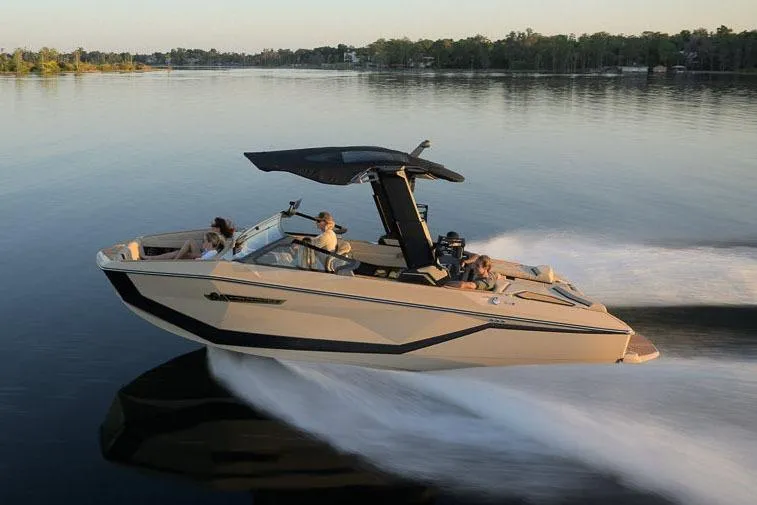 Slide: The Image of Manufacturer Provided Image: 2026 Nautique Super Air Nautique G23 cruising on a serene lake at sunset. - 12