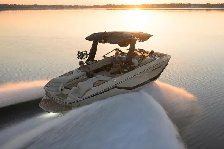 Slide: The Image of Manufacturer Provided Image: 2026 Nautique Super Air Nautique G23 cruising on a serene lake at sunset. - 14
