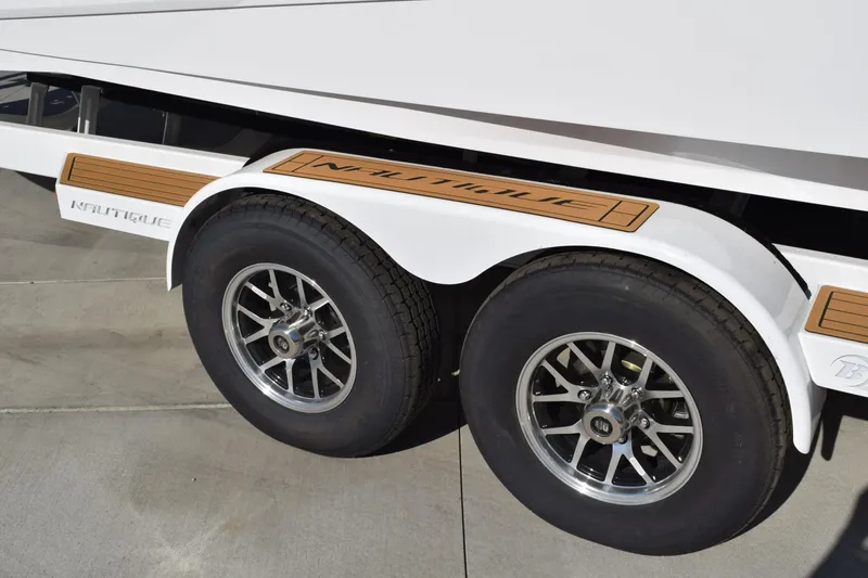 Slide: The Image of 2026 Nautique Super Air Nautique G23 trailer with dual wheels and branded fender. - 3