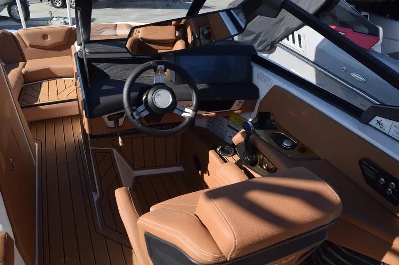 Slide: The Image of 2026 Nautique Super Air Nautique G23 interior with luxurious tan leather seating and modern dashboard. - 4