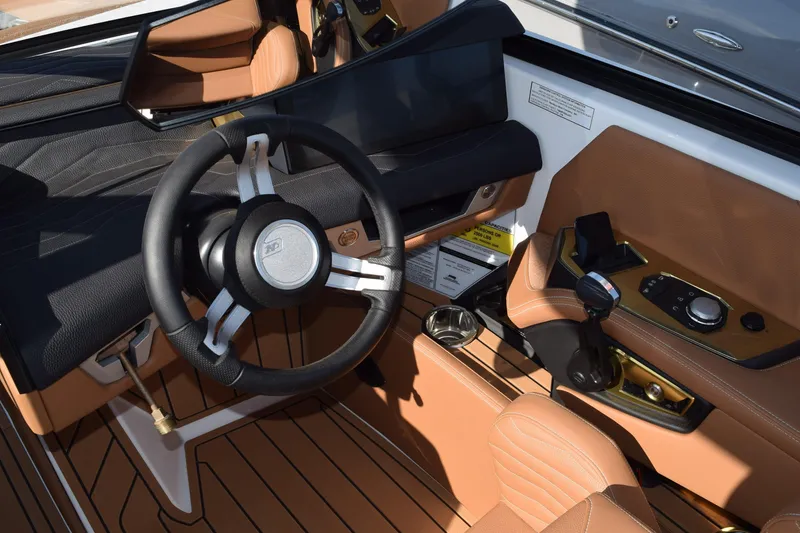 Slide: The Image of 2026 Nautique Super Air Nautique G23 cockpit with sleek steering wheel and modern controls. - 5