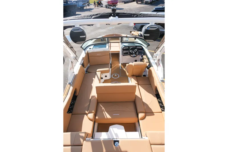 Slide: The Image of 2026 MasterCraft NXT23 boat interior with tan seating and modern dashboard. - 13