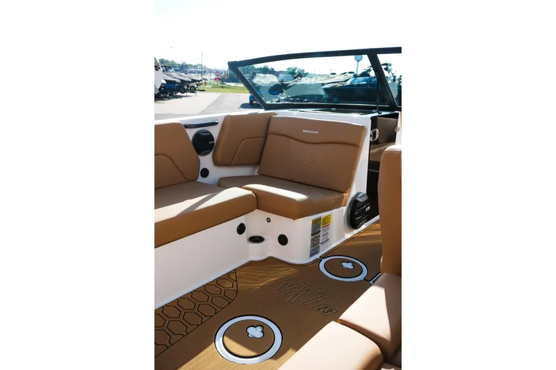 Slide: The Image of 2026 MasterCraft NXT23 boat interior with tan seating and stylish flooring. - 20