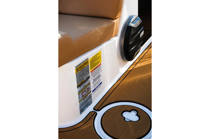 Slide: The Image of 2026 MasterCraft NXT23 interior detail with seating and safety labels. - 21