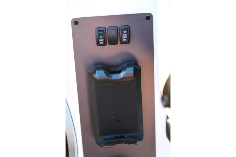 Slide: The Image of Control panel of 2026 MasterCraft NXT23 boat with switches and holder. - 23