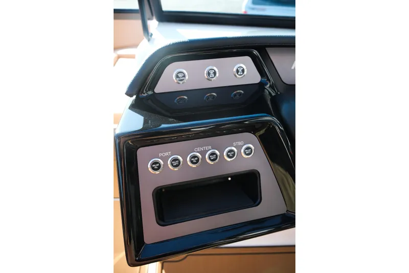 Slide: The Image of 2026 MasterCraft NXT23 boat dashboard with control buttons and sleek design. - 25