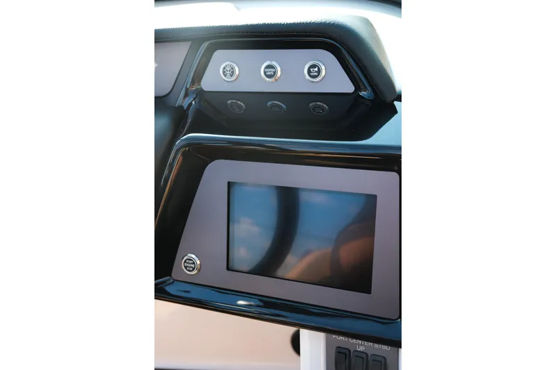 Slide: The Image of Dashboard of 2026 MasterCraft NXT23 boat with touchscreen and control buttons. - 26