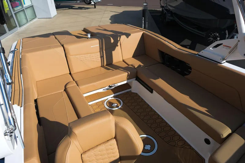 Slide: The Image of 2026 MasterCraft NXT23 boat interior with tan seating and hexagonal floor design. - 29